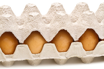 Image showing Brown eggs in a carton package on white background