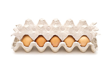 Image showing Brown eggs in a carton package on white background