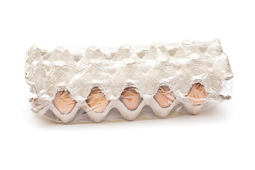 Image showing Brown eggs in a carton package on white background