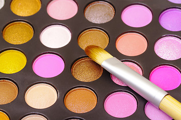 Image showing Set of multicolored eyeshadows with makeup brush