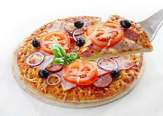 Image showing Pizza with salami, bacon, tomato and black olives