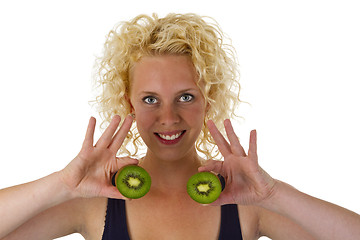 Image showing Young woman holding Kiw Fruit