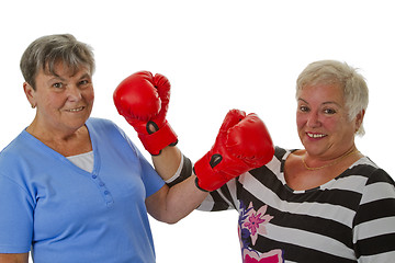 Image showing Two female seniors with red boxing glove