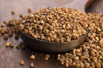 Image showing Buckwheat seeds on wooden spoon in closeup 