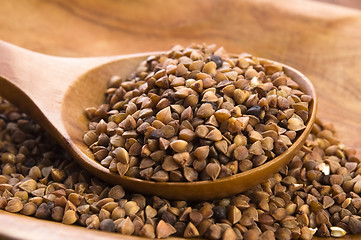 Image showing Buckwheat seeds on wooden spoon in closeup 