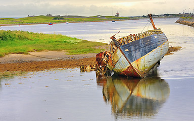 Image showing boat wreck lying on the shore of lake