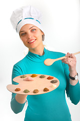 Image showing Spices and herbs on the palette and cook girl 