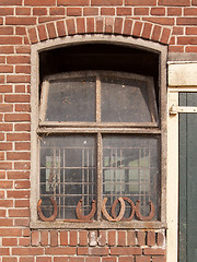 Image showing Horseshoes in front of a window