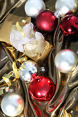 Image showing Christmas baubles on gold fabric