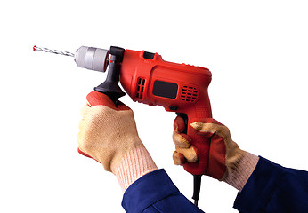 Image showing Gloved hands with electric drill