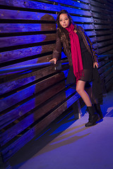 Image showing Mixed Race Young Adult Woman Against a Wood Wall Background