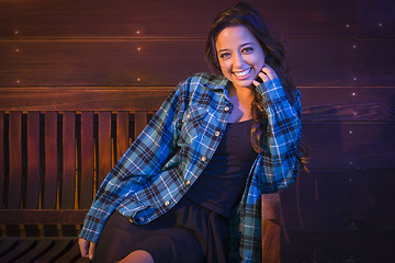 Image showing Mixed Race Young Adult Woman Portrait Sitting on Wood Bench