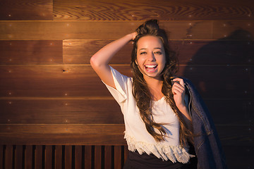 Image showing Mixed Race Young Adult Woman Portrait Against Wooden Wall