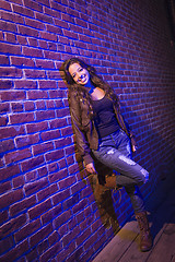 Image showing Pretty Mixed Race Young Adult Woman Against a Brick Wall