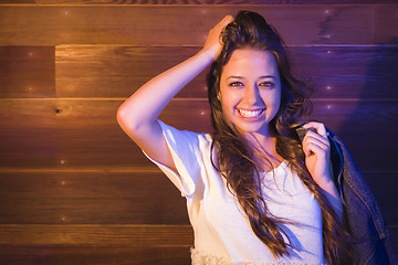 Image showing Mixed Race Young Adult Woman Portrait Against Wooden Wall