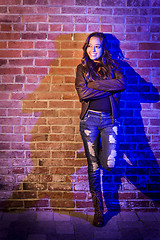 Image showing Pretty Mixed Race Young Adult Woman Against a Brick Wall