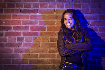 Image showing Pretty Mixed Race Young Adult Woman Against a Brick Wall