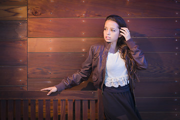 Image showing Mixed Race Young Adult Woman Portrait Against Wooden Wall