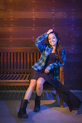 Image showing Mixed Race Young Adult Woman Portrait Sitting on Wood Bench