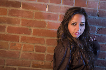 Image showing Pretty Mixed Race Young Adult Woman Against a Brick Wall