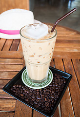 Image showing Cold glass of milk espresso and heart ice cube  