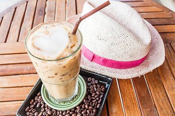 Image showing Cold glass of iced milk coffee on wood table
