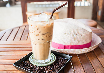 Image showing Cold glass of iced milk coffee with ice cube  
