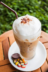 Image showing Refreshing iced milk coffee and some sweet