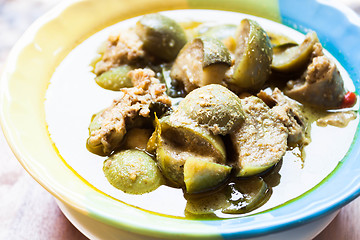 Image showing A bowl of spicy green curry with chicken and eggplant