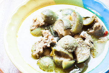 Image showing A bowl of spicy green curry with chicken and eggplant