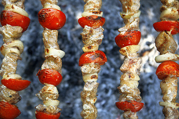 Image showing meat with tomatoes on a grill