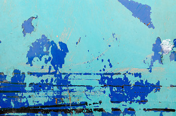 Image showing old peeled paint rusty barrel wall blue background 