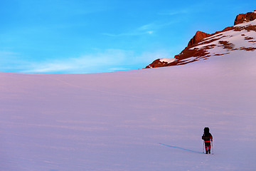 Image showing Hiker in sunrise snow mountains