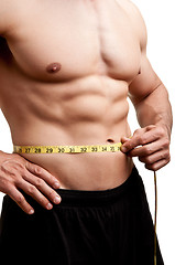 Image showing Fit Man Measuring His Waist