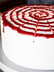Image showing Rasberry sauce topped white whipped cream cake 
