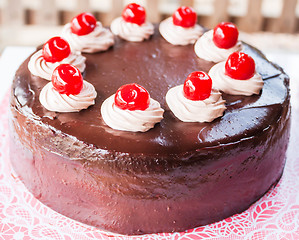 Image showing Delicious chocolate cake with red cherry on top