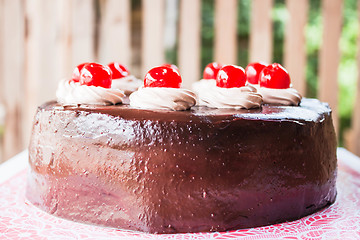 Image showing Fresh bake chocolate cake topped with cherry