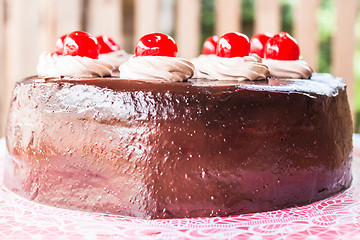 Image showing Home made chocolate cake topped with cherry