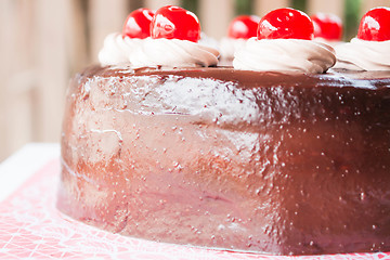 Image showing Delicious chocolate cake with cherry on top