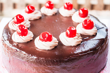 Image showing Chocolate cake with cherry and whipped cream 