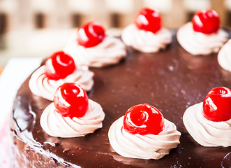 Image showing Close up chocolate cake with cherry and whipped cream 