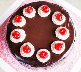 Image showing Chocolate cake with whipped cream and cherry