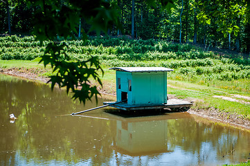 Image showing farm building water pump on lake