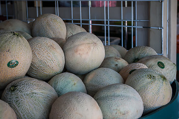 Image showing Group of fresh ripe cantaloupe on display in produce market