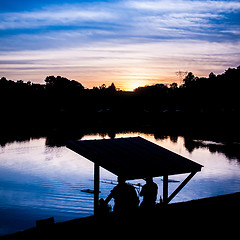 Image showing fisherman fishing at  sunset