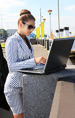 Image showing woman with computer on quay