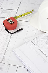 Image showing Red measuring tape on construction plans