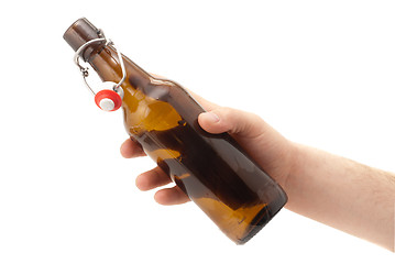 Image showing Hand holds a bottle of beer. Isolated on white 