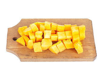 Image showing Slices of pumpkin and cutting board,isolated on white background 