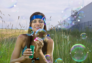 Image showing woman blows soap bubbles
